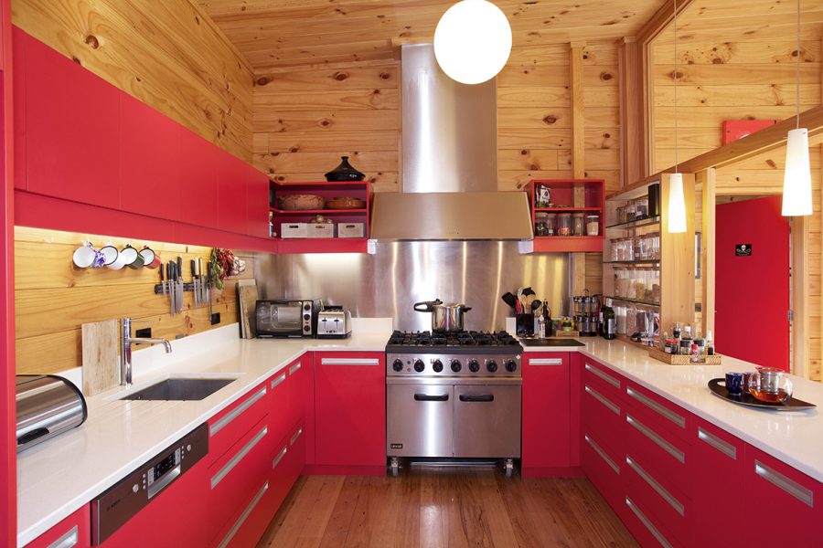 Lockwood Home Kitchen with Red Design and Stainless Steel Splashback