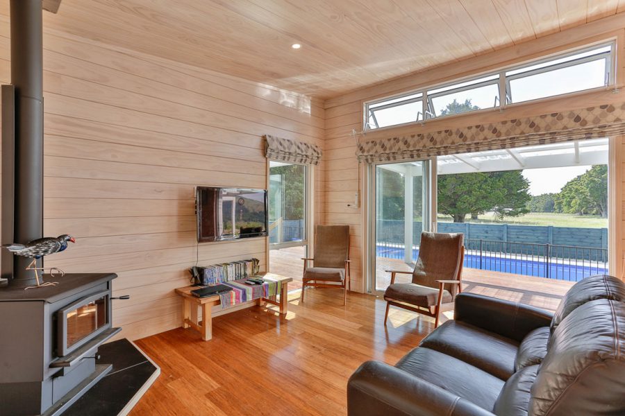 Lockwood Home Living Room with Fireplace, Ranch Slider and Pool View