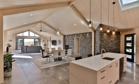 Lockwood home with schist stone wall in dining and living area